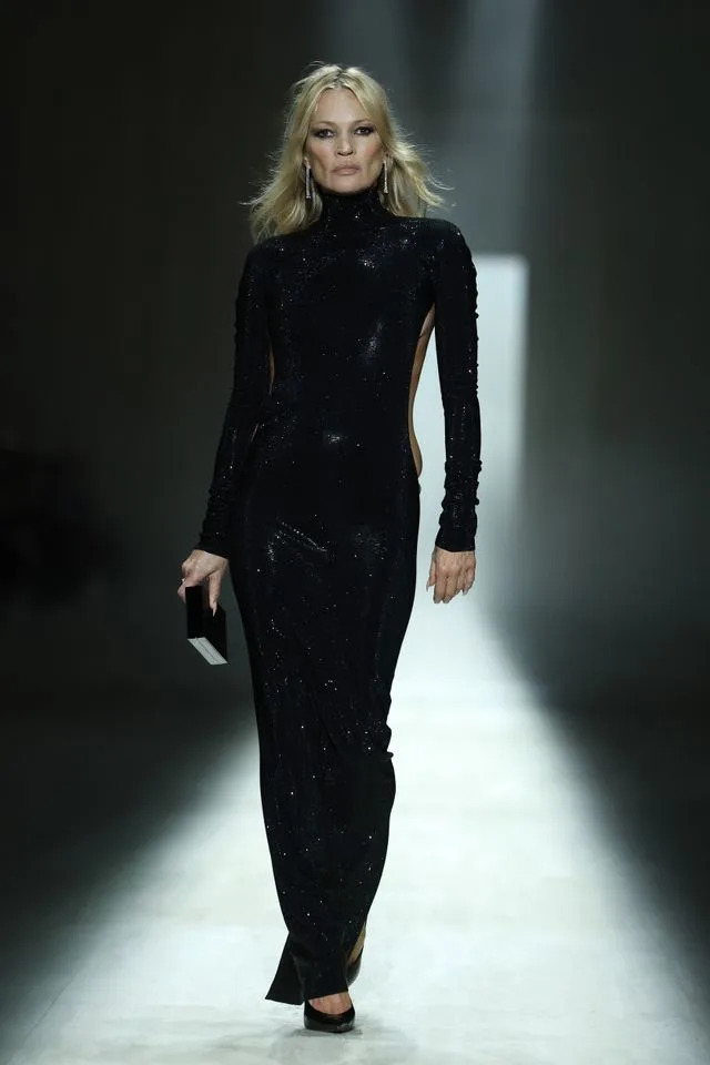 Moss wore a slinky sparkly black dress with side cutouts.Credit: Getty