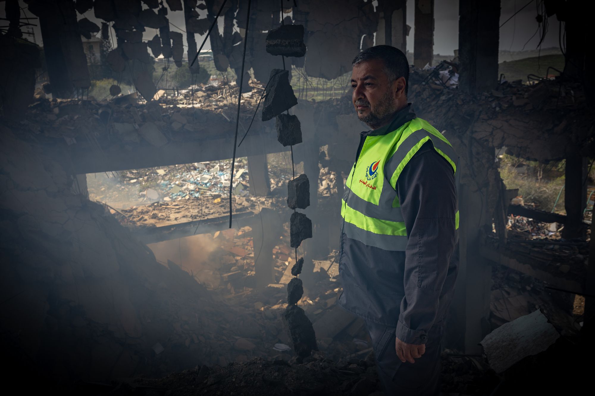 Abdullah Nour al-Din from the Islamic Health Authority stands inside the remains of a medical centre in southern Lebanon