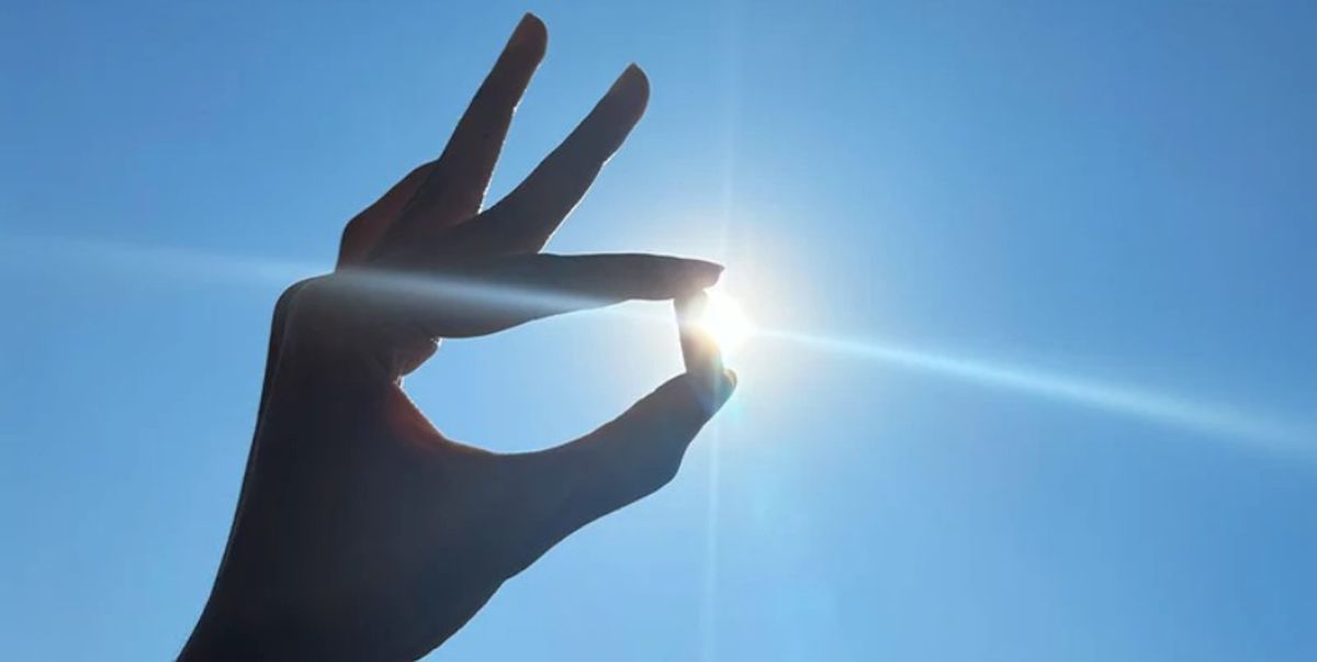 Someone holding a capsule up against sunlight