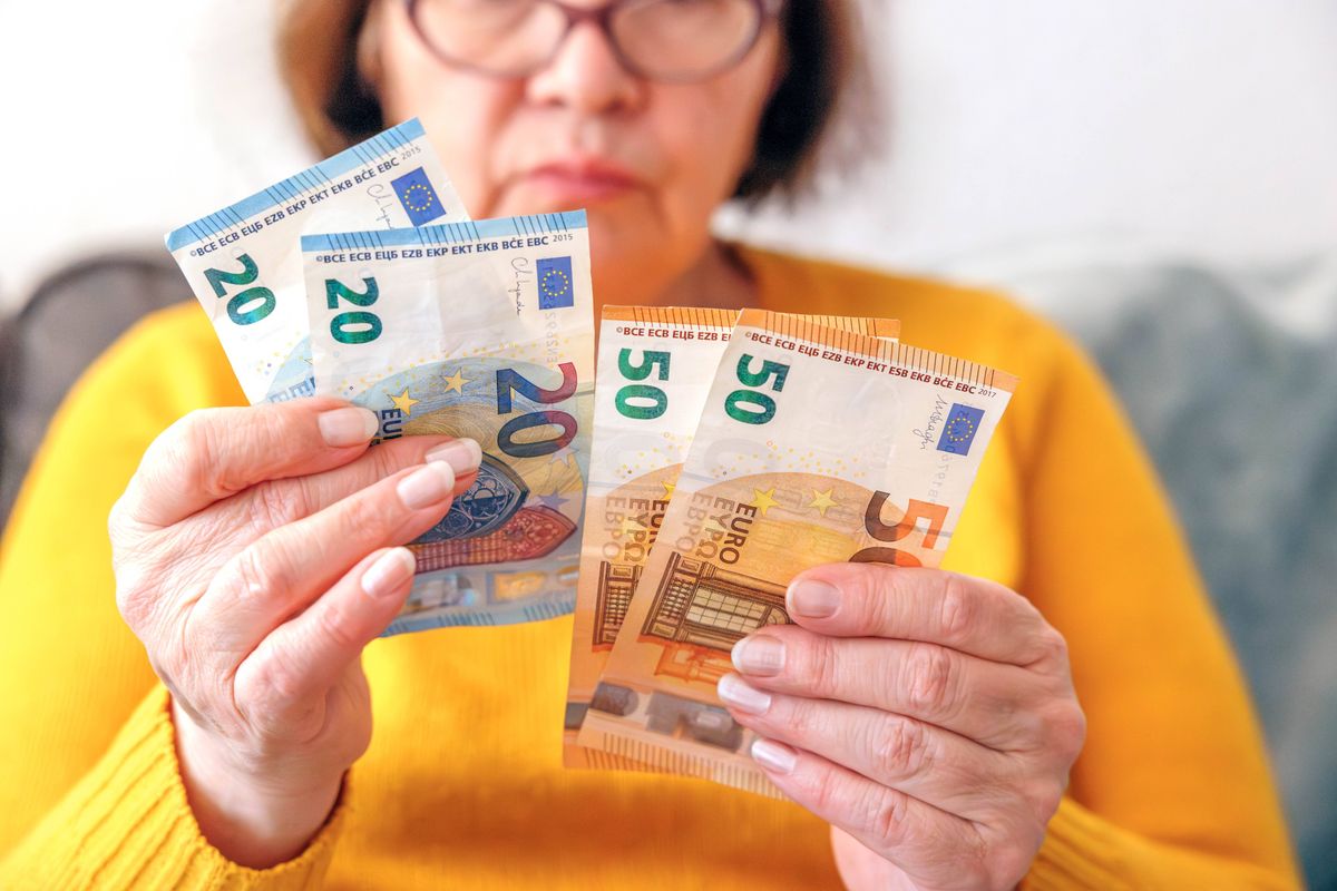 A woman holding euro notes