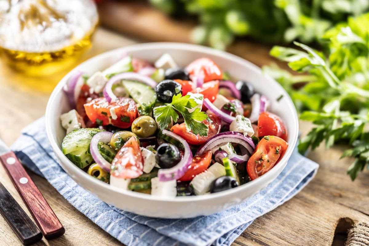 A healthy Mediterranean salad of Greek origin consisting of tomatoes, cucumbers, olives and Feta cheese, seasoned with parsley and olive oil