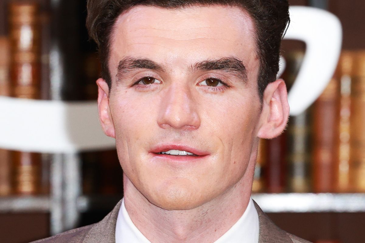 A man smiles in a promotional setting