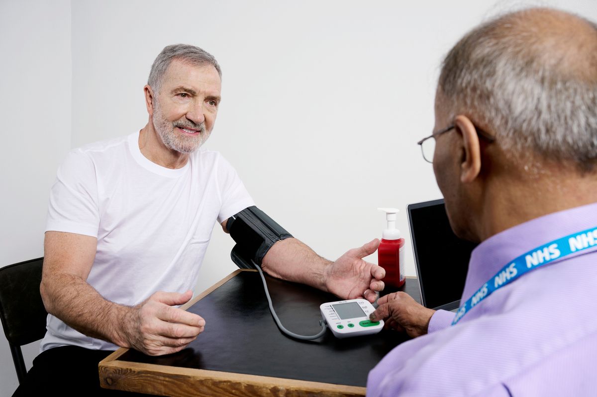 High cholesterol can cause high blood pressure  - blood pressure check being carried out