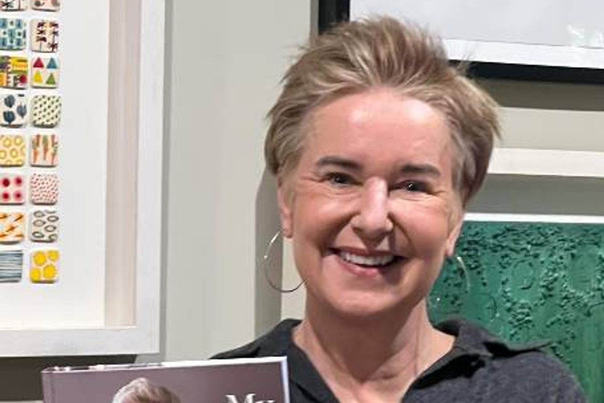 Eunice Power holding her cookbook