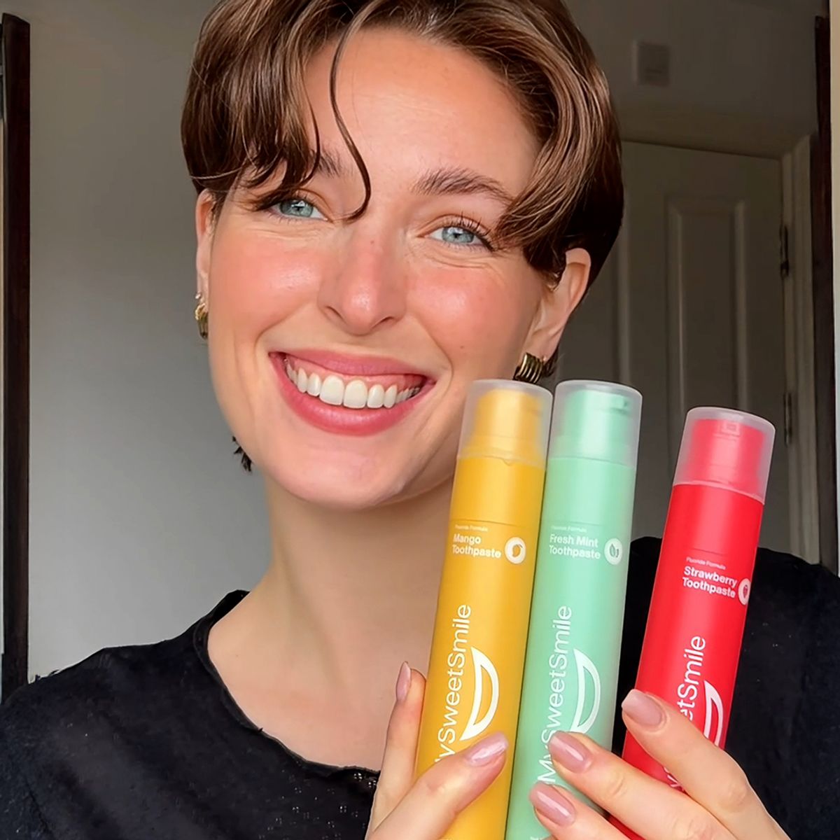 Woman holding MySweetSmile products