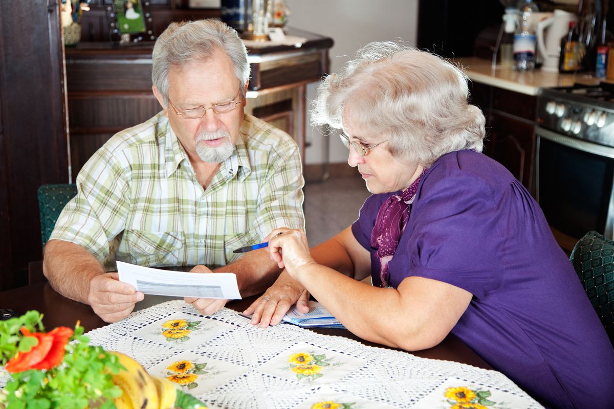 An older couple looking at their bills