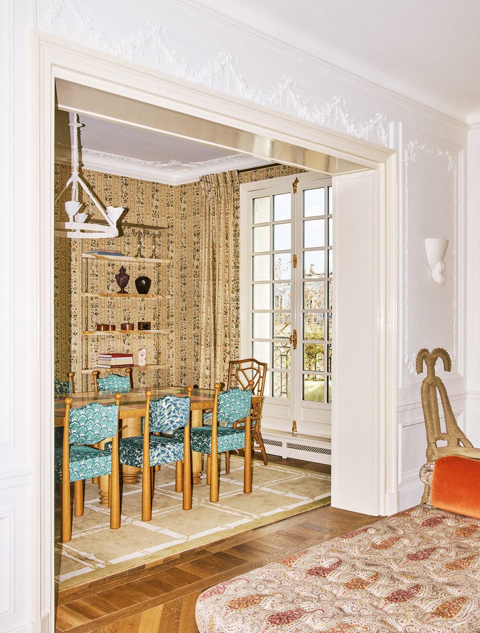 Dining area with decorative elements and furniture viewable from another room.