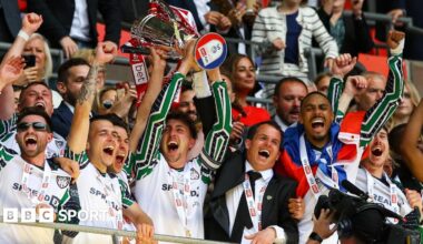 Sunderland players celebrate by lifting the Championship play-off final trophy at Wembley in May 2025