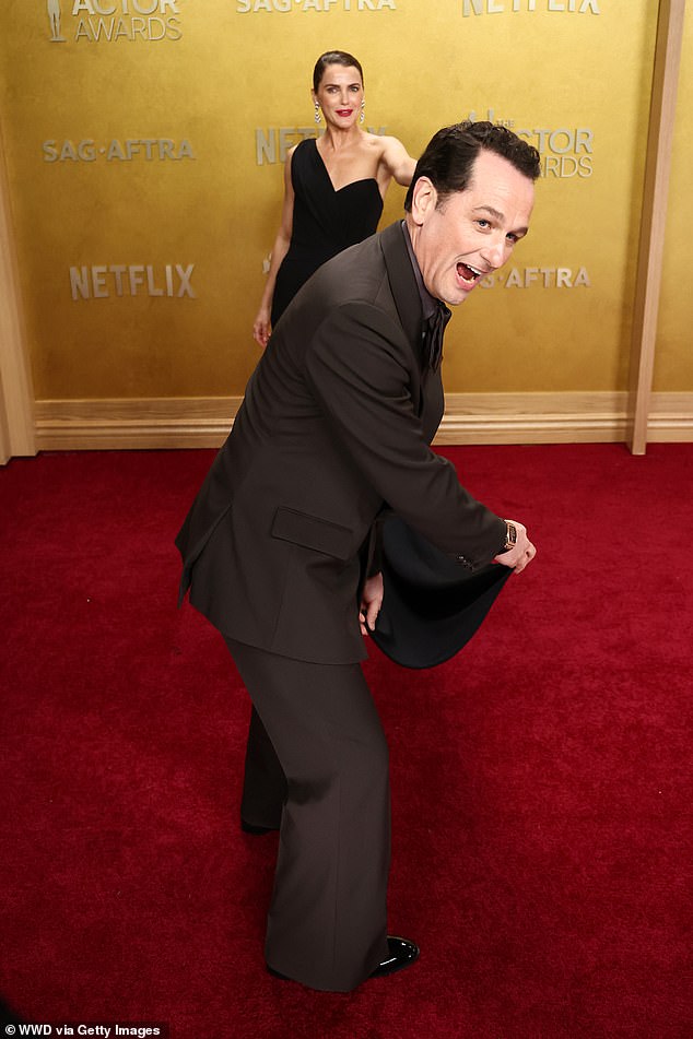 The actor put on an animated display as he tried to fan out Keri's dress