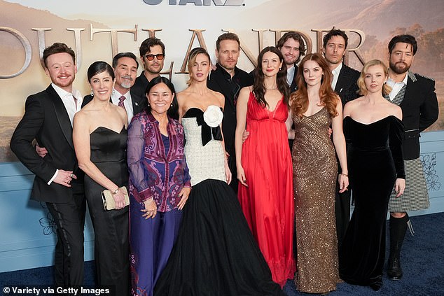 Pictured left to right: John Bell, Maril Davis, Matthew B. Roberts, David Berry, Diana Gabaldon, Sophie Skelton, Sam Heughan, Caitriona Balfe, Charles Vandervaart, Izzy Meikle-Small, Cesar Domboy, Lauren Lyle and Richard Rankin
