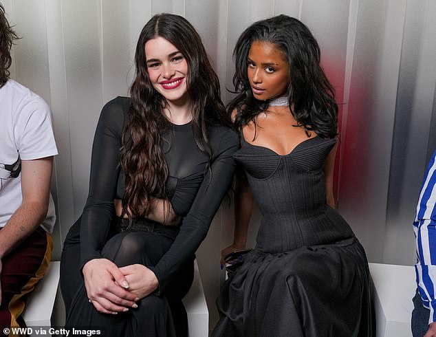 The stylish pair beamed as they took their seats