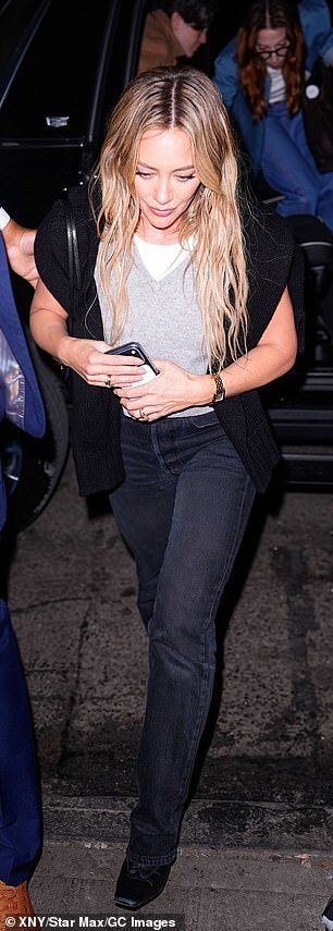 The 38-year-old former Disney Channel star was dressed preppy in a grey vest over a white tee with a black cardigan slung over her shoulders