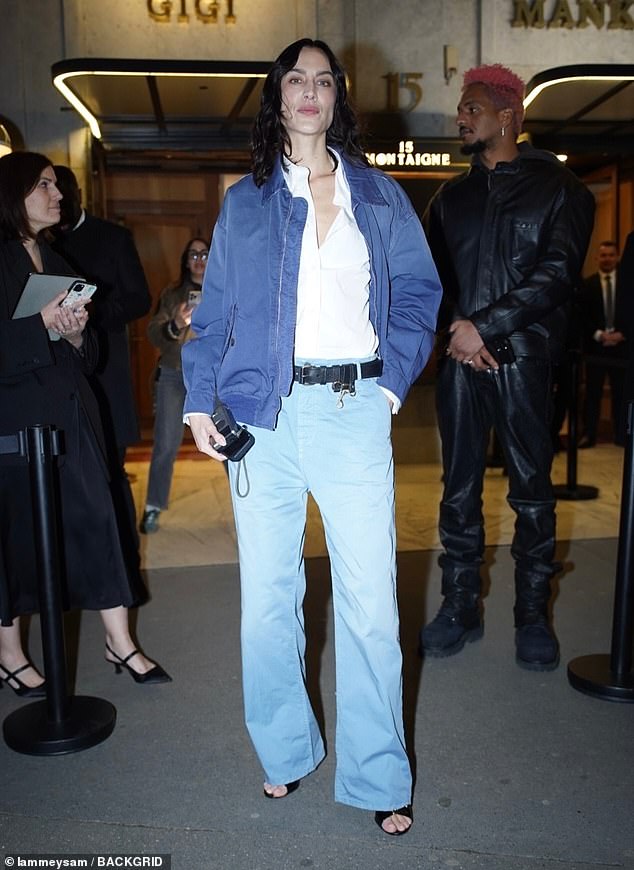 The model, 42, added a blue bomber jacket over the shirt and cinched in her waist with a chunky black belt