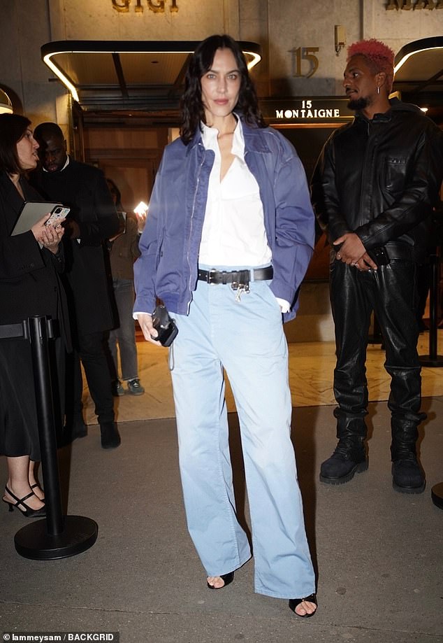 Alexa Chung cut a cool figure as she tucked a crisp white shirt into a pair of blue denim wide legged jeans
