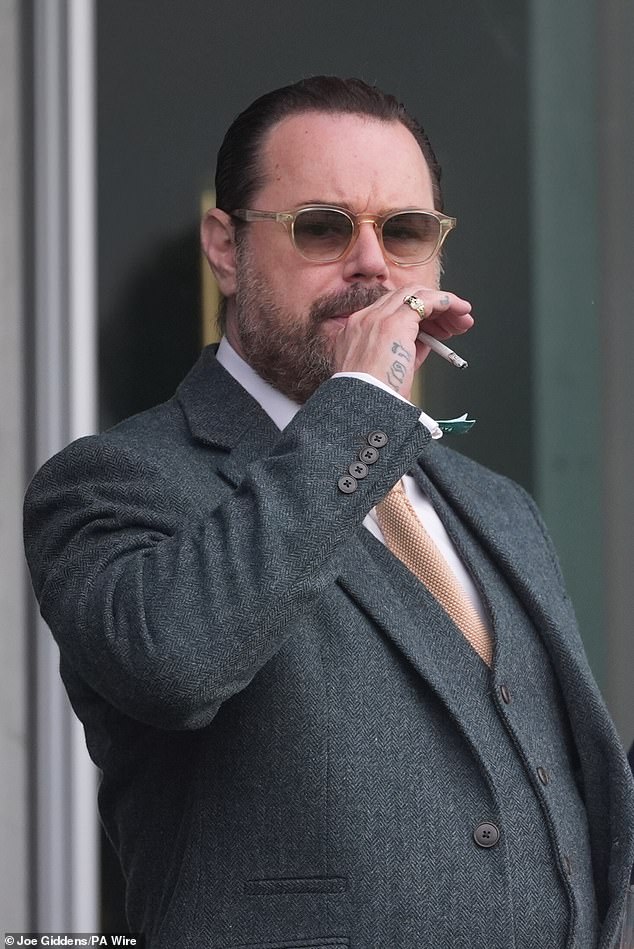 Danny was puffing on a cigarette during the races