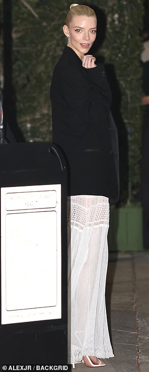 Throwing a loose-fitted black blazer over the ensemble, she swept her flaxen hair tightly back, emphasizing her luminous complexion and unmistakable features