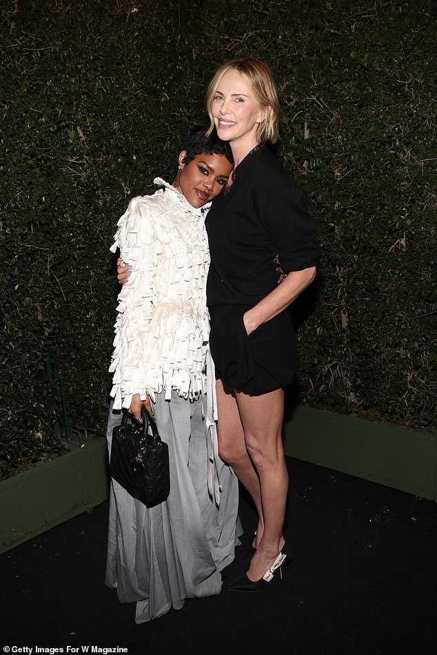 Teyana Taylor enjoyed a cuddle with Charlize at the party