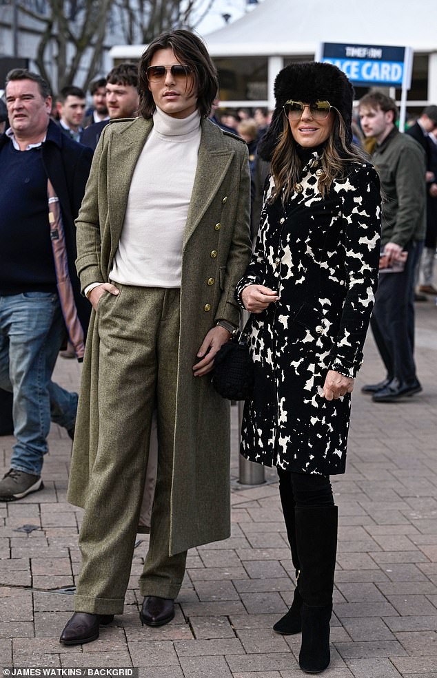 Elizabeth Hurley cut a glamorous figur in a black and white floral print coat as she attended the festival alongside her son Damian