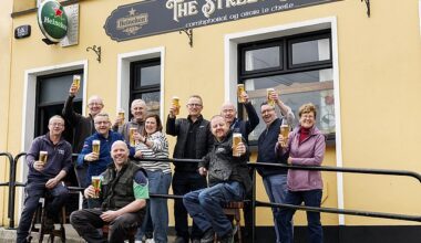 Locals raise a pint outside The Street Bar in the village of Kilteely, Co. Limerick