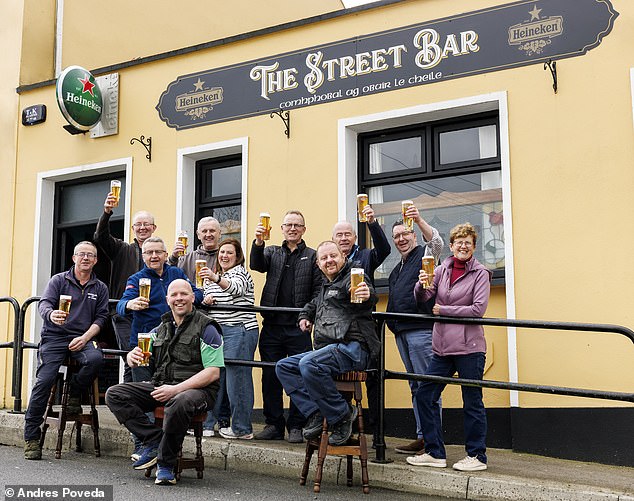 Locals raise a pint outside The Street Bar in the village of Kilteely, Co. Limerick