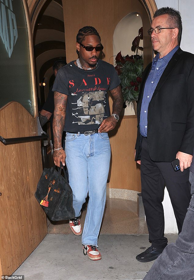 Stefon Diggs carried a large suede Birkin handbag as he exited