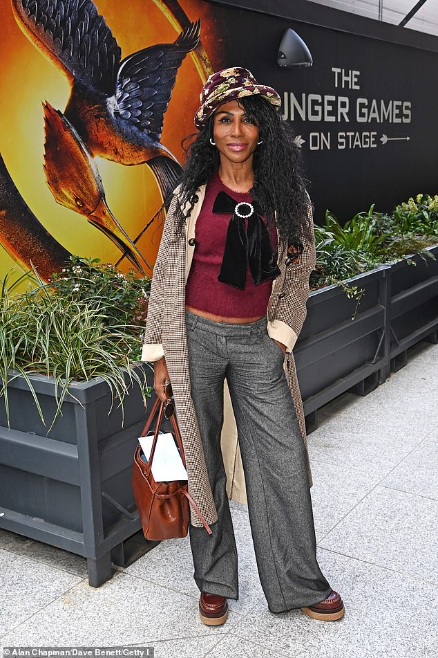 Iocnic songstress Sinitta teased a glimpse of her trim midriff as she posed up a storm