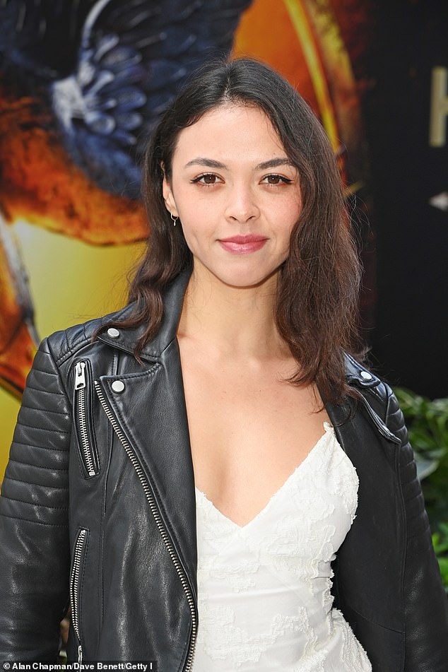 She layered the plunging look with a leather motorcycle jacket