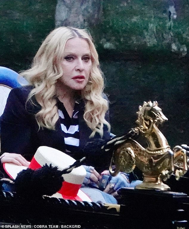 The stars coordinated in black and white horizontally striped shirts and black coats