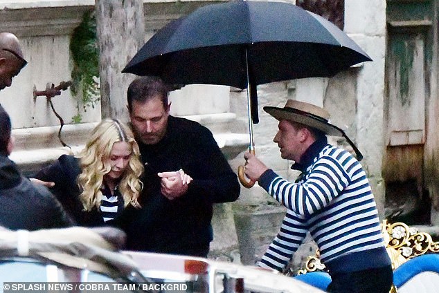 Madonna was helped onto the boat by assistants