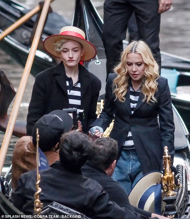 The stars coordinated in black and white horizontally striped shirts and black coats