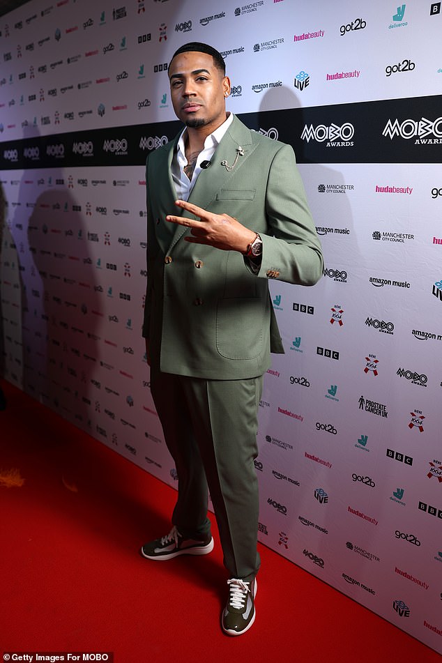 Tyrique Hyde looked dapper in a green suit paired with a crisp white shirt