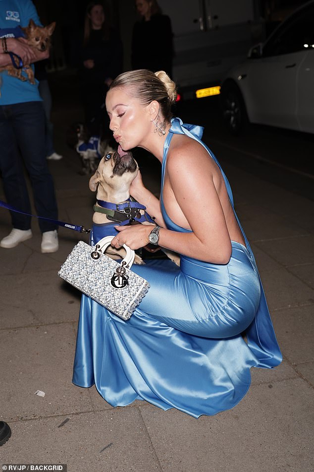 Tasha Ghouri received a lick from a dog as she arrived at the gala