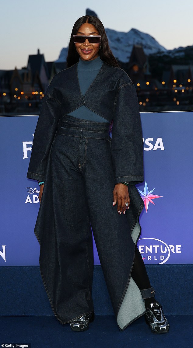 Naomi completed her outfit with striking black and blue chunky trainers and a pair of visor sunglasses
