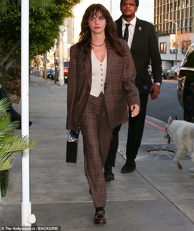 Meanwhile, Cara, 33, who was also spotted arriving at the exclusive venue, cut a sophisticated look in a brown patterned two-piece suit