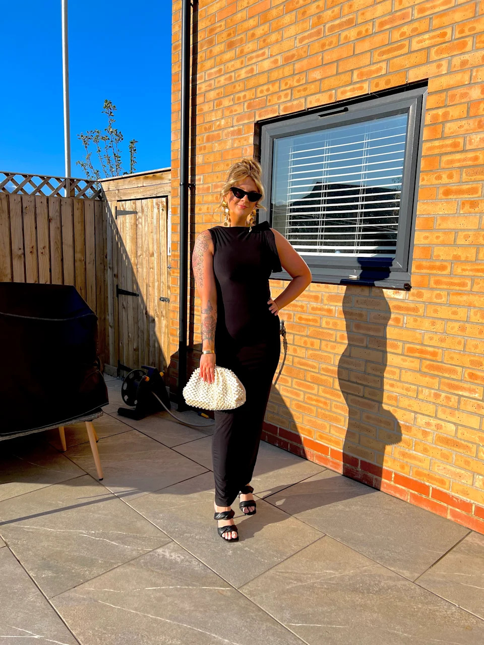 Katie with a purse in a backyard