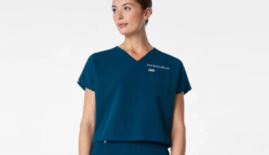 A photo of a woman wearing a FIGS cropped scrub top.