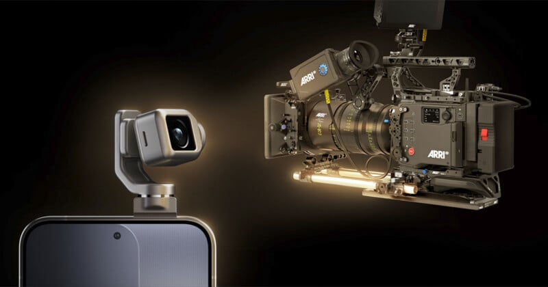 A close-up of a smartphone with a small camera module attached, facing a large professional ARRI cinema camera against a dark background. Both cameras are highlighted, emphasizing a contrast in size and technology.