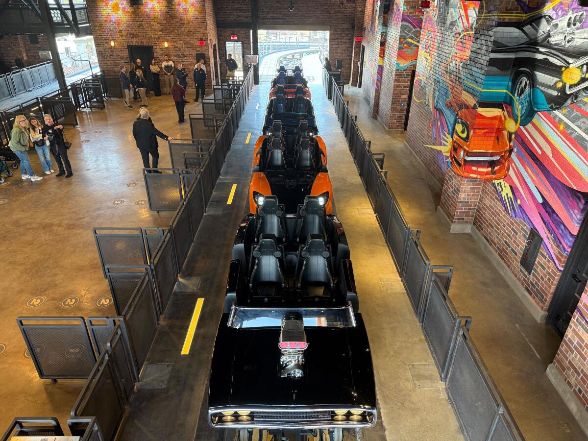 A car-themed roller coaster in a warehouse. 