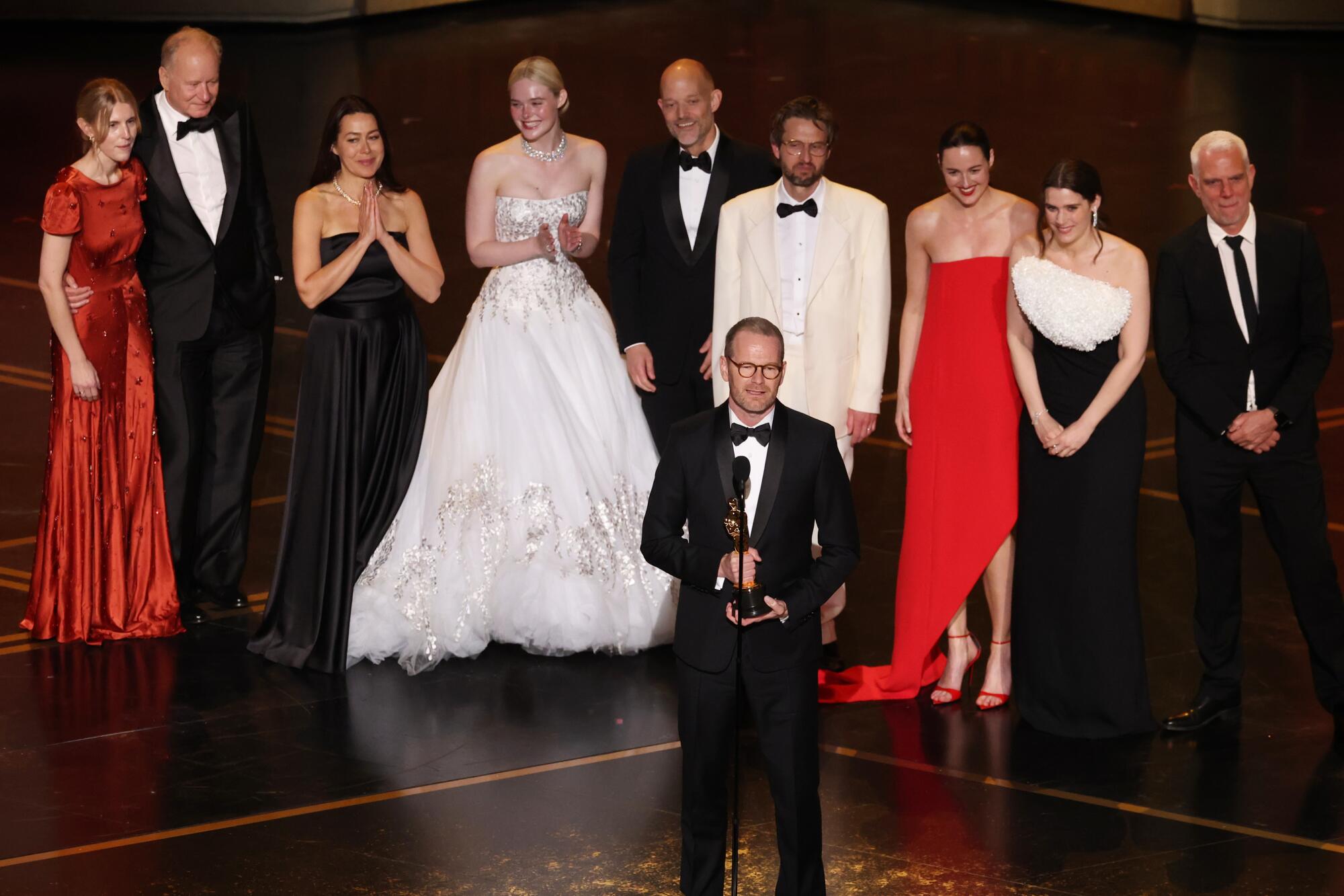 Joachim Trier accepts the Oscar for international feature with the cast of "Sentimental Value" during the 98th Oscars.