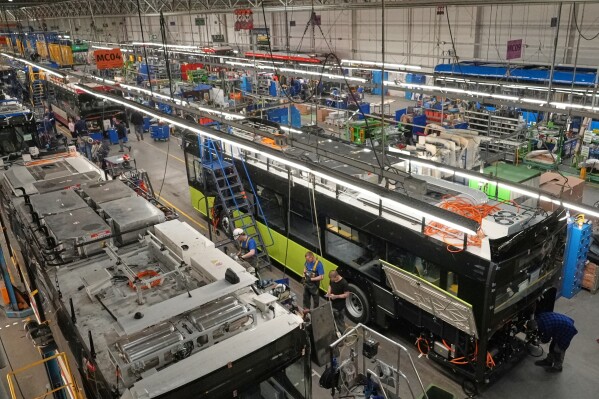 Workers build electric buses at the Solaris bus factory in Poznan, Poland, Thursday, Jan. 29, 2026. (AP Photo/Pietro De Cristofaro)