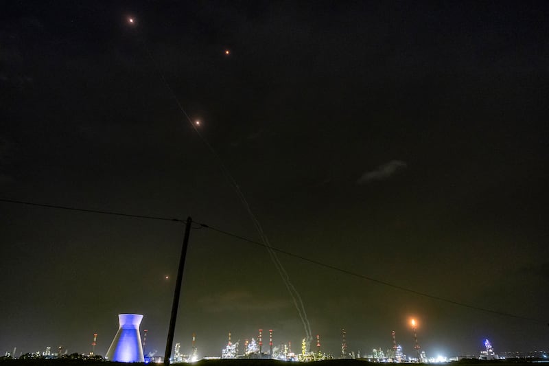 Lights from missile defence interceptors are seen in the sky above the oil refinery in Israel's northern city of Haifa on Thursday night.   Photograph:  Odd Andersen/AFP