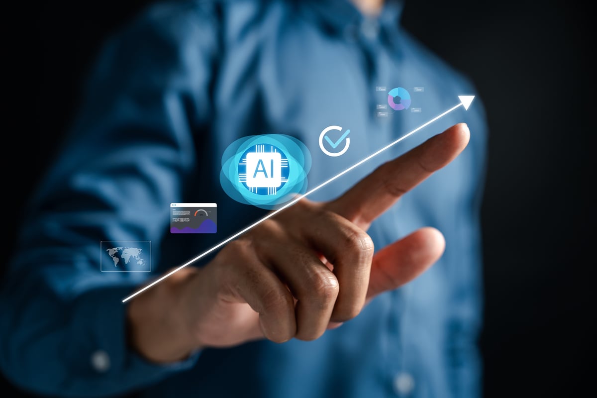 Person tracing an arrow moving up and to the right with various icons above it, including an AI chip.