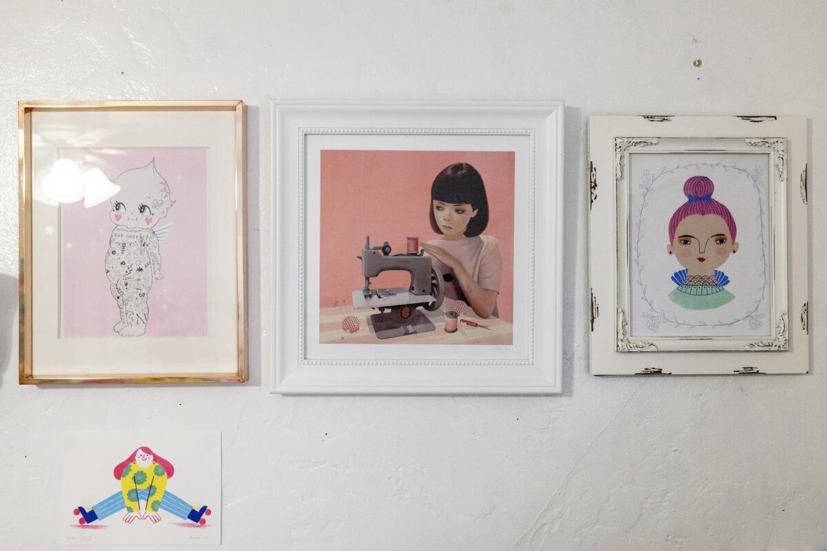 Jars of colorful sand and sweet artwork fills Naoshi's studio.
