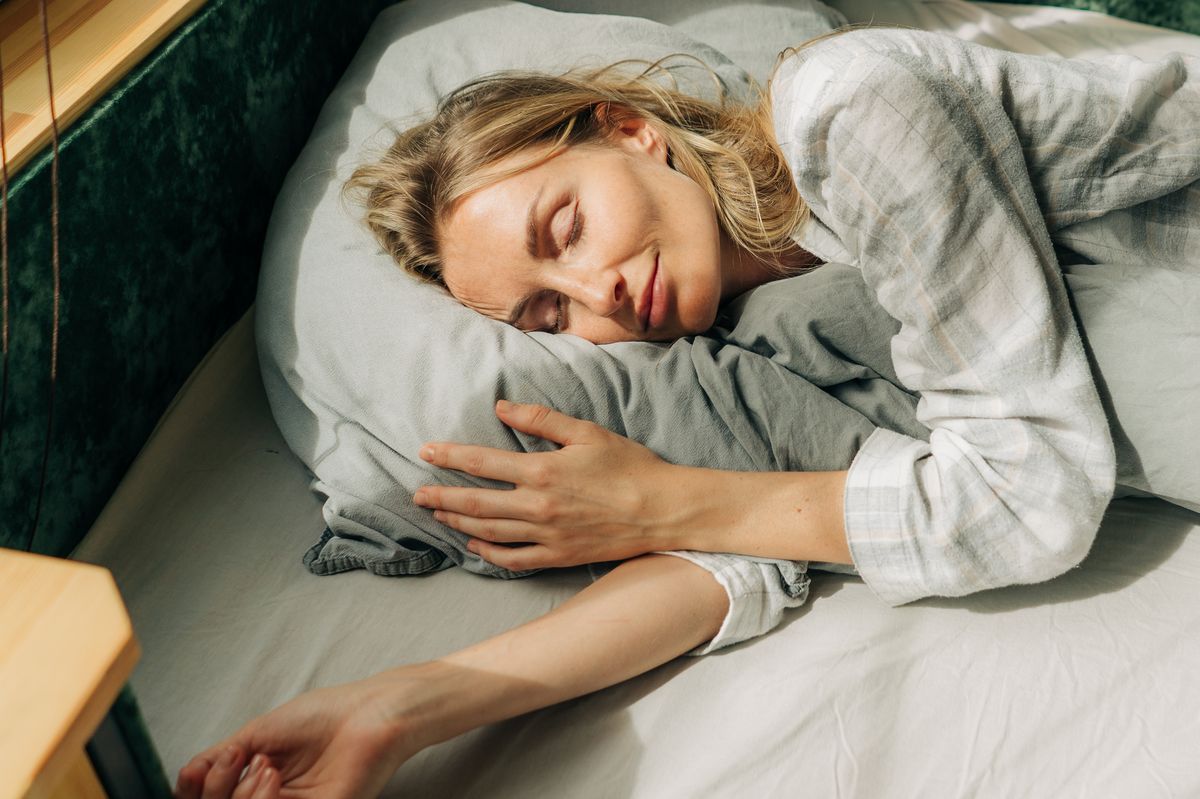 Portrait of a woman sleeping on a bed 