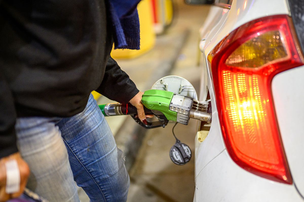 A woman fills her car up with petrol (Photo by Alexi J. Rosenfeld/Getty Images)