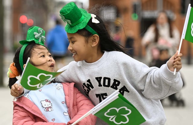 Two children wave green flags