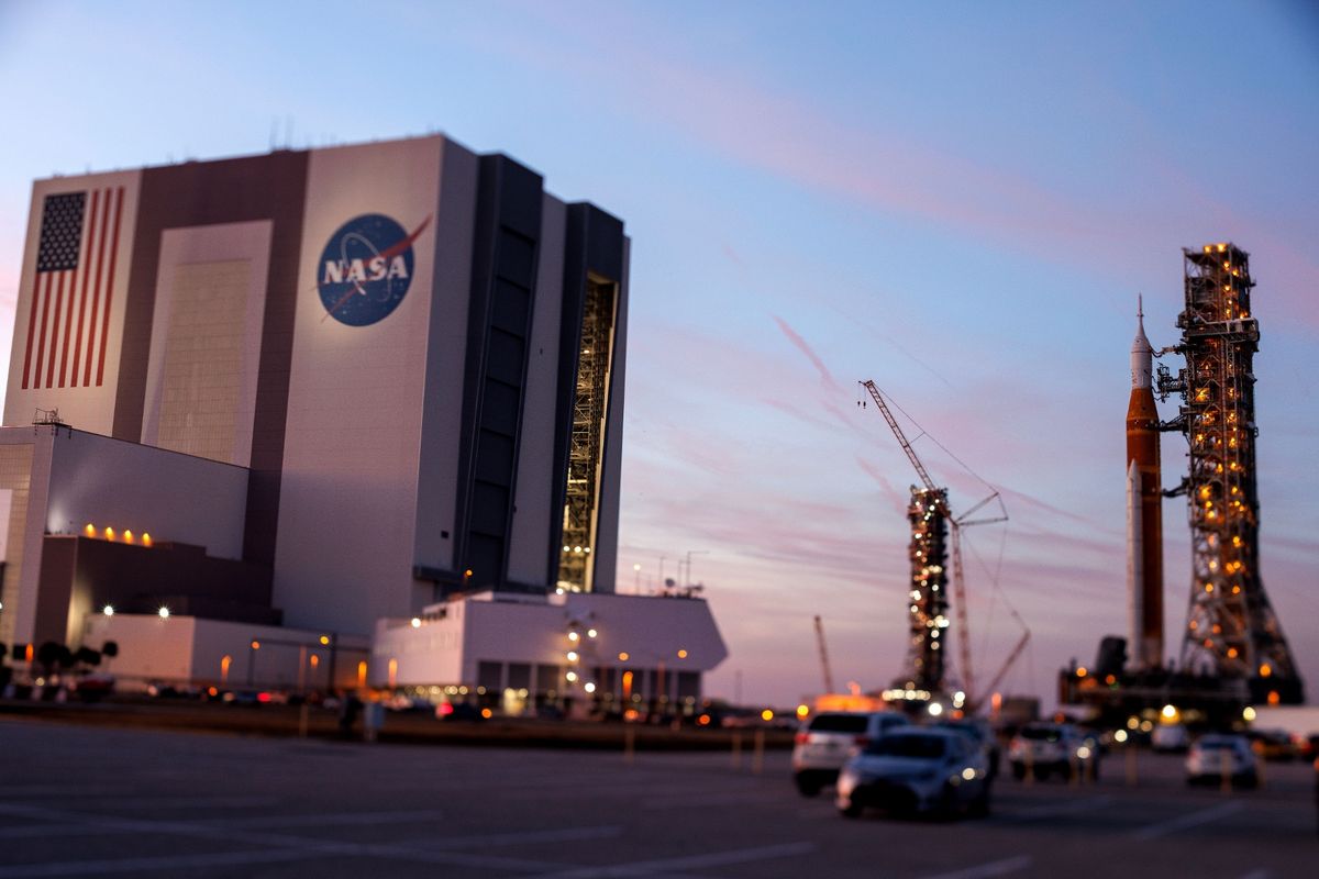The SLS rocket with an Orion capsule, part of the Artemis 2 mission, being transported back to the Vehicle Assembly Building