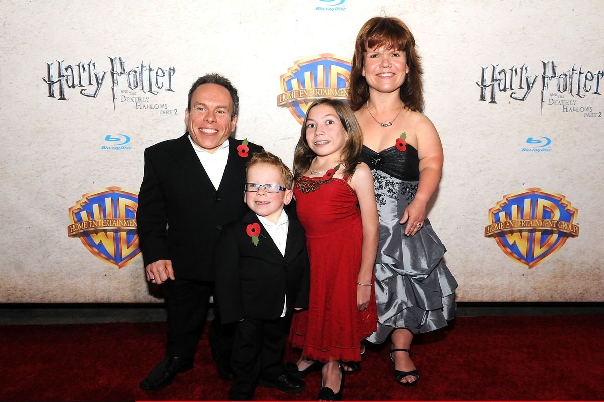 Actor Warwick Davis (L) and his wife actress Samantha Davis (R) and their children