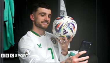 Troy Parrott poses with the match ball after his hat-trick against Hungary in Budapest