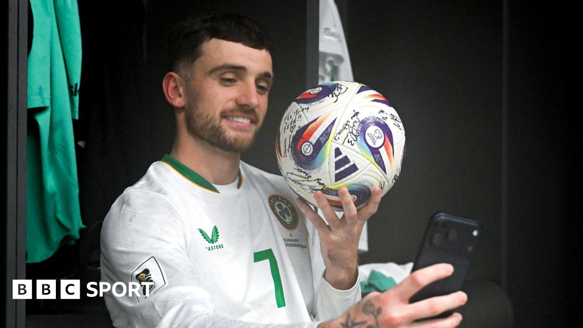Troy Parrott poses with the match ball after his hat-trick against Hungary in Budapest
